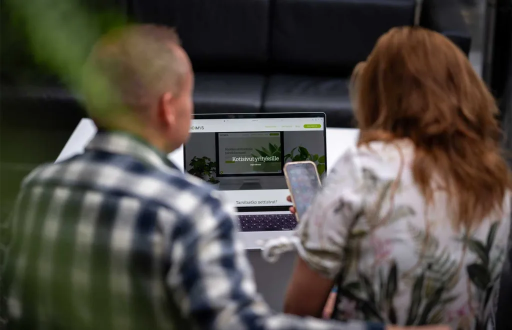 Digimys Oy yrittäjät Pekka ja Katri katsovat puhelimen ruutua